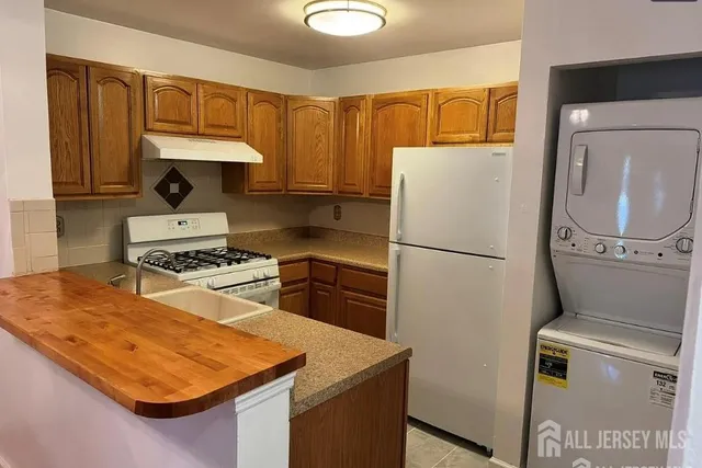 a kitchen with a refrigerator sink and stove