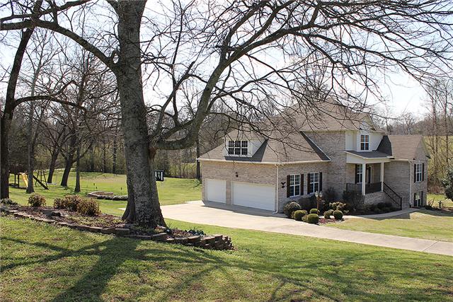 975 Rip Steele Road Columbia, TN 38401 - Photo 2 of 20 The home is full brick and contains a 3 car garage. It also has a wooden playset and firepit area.