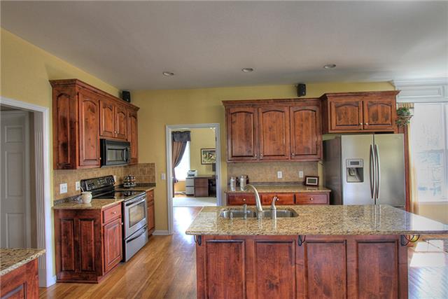 975 Rip Steele Road Columbia, TN 38401 - Photo 5 of 20 All appliances remain in this beautiful kitchen! Granite countertops, under cabinet lighting, and a large island will also be favorites of the new owners. The laundry room and half bath are to the left.