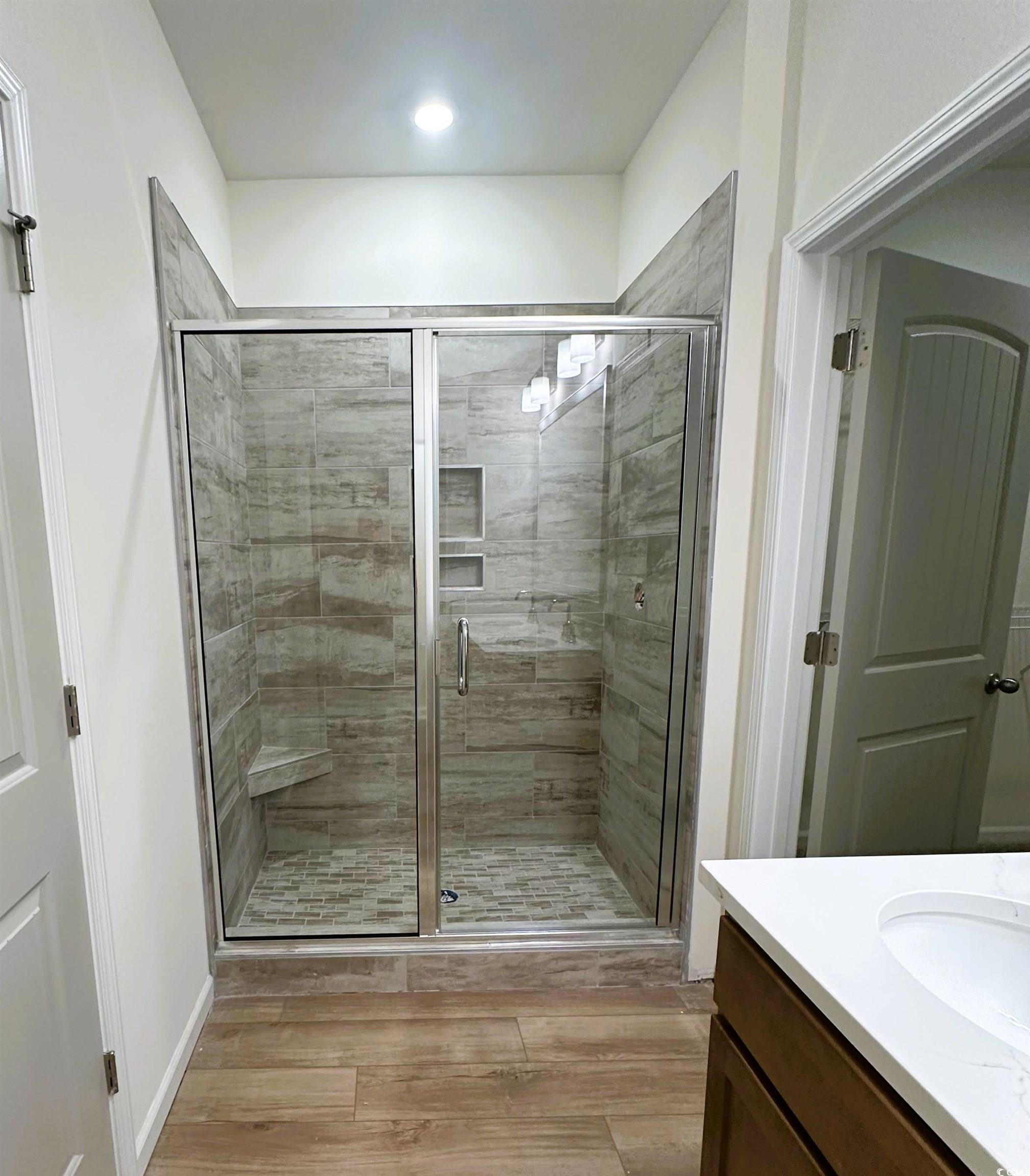 892 Birch Gdn Drive Longs, SC 29568 - Photo 9 of 15 Full bath with vanity, a stall shower, and light wood-type flooring