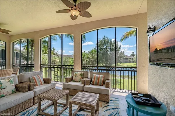 a kitchen with stainless steel appliances a stove a sink a counter space a large window and cabinets