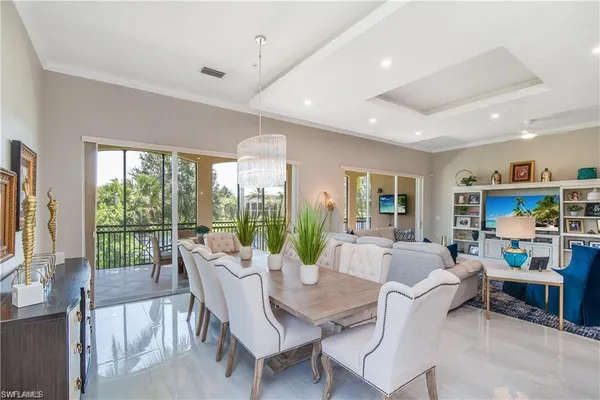 a living room with furniture a flat screen tv and a large window
