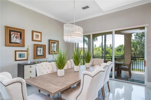 a living room with furniture a table and a large window