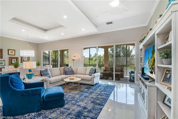 a living room with furniture large windows and a rug