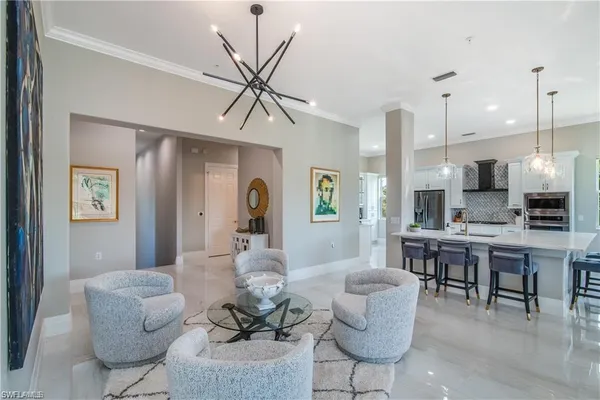 a living room with furniture and a view of kitchen