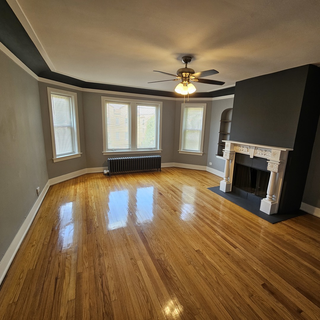 424 Wisconsin Avenue, Unit 3N Oak Park, IL 60302 - Photo 3 of 20 a view of a livingroom with wooden floor and a fireplace