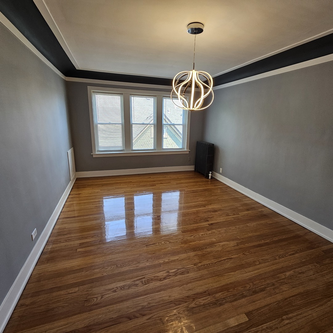 424 Wisconsin Avenue, Unit 3N Oak Park, IL 60302 - Photo 10 of 20 a view of empty room with wooden floor and window
