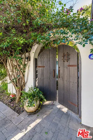 a patio with a table and chairs under an umbrella