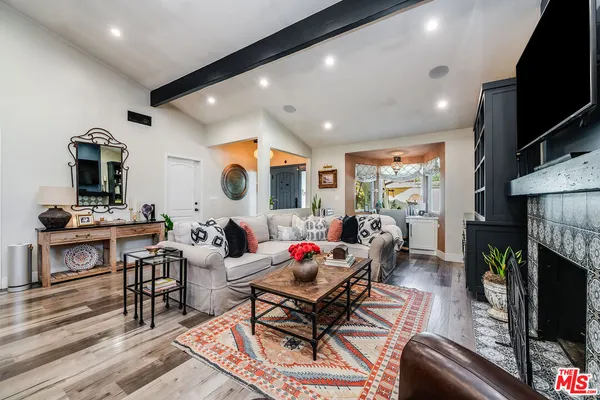a living room with fireplace furniture and a flat screen tv