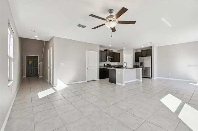 a kitchen with stainless steel appliances granite countertop a stove a microwave and cabinets