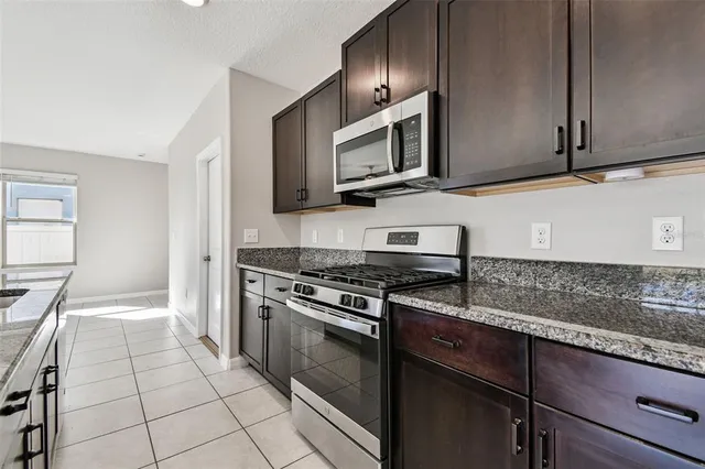 an empty room with a ceiling fan and a window