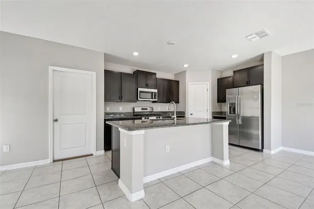 an empty room with closet and a chandelier fan