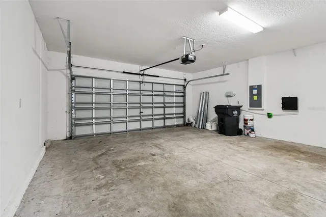 an empty room with a window and ceiling fan