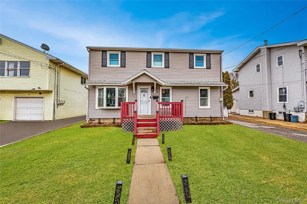a front view of house with yard and green space