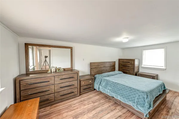 a bedroom with a bed and window