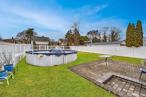 a swimming pool with outdoor seating and yard