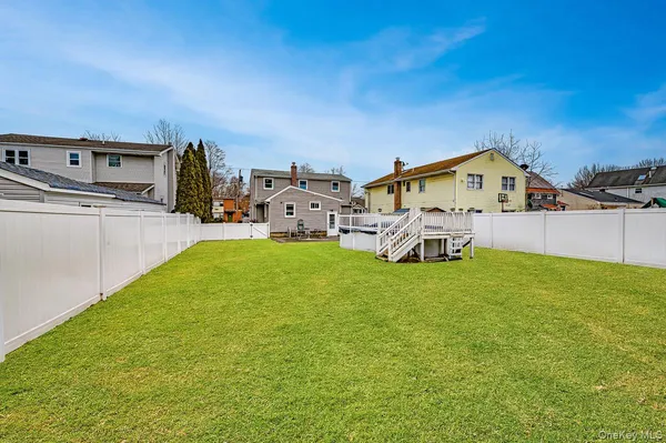 a view of a house with a big yard and large trees