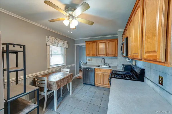 a kitchen with a stove a sink and cabinets