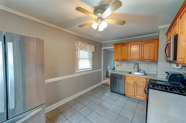 a kitchen with stainless steel appliances granite countertop a stove a sink and a refrigerator