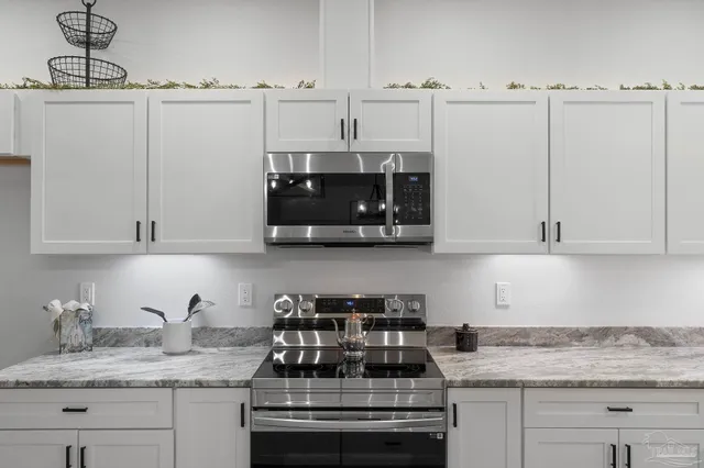 a kitchen with appliances cabinets and a counter top space