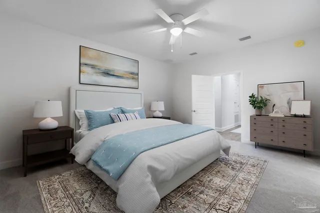 a bedroom with a large bed and a chandelier