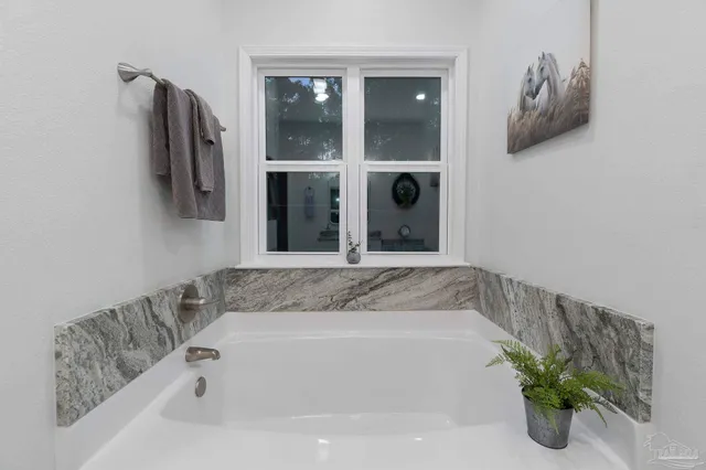 a bathroom with a tub and shower