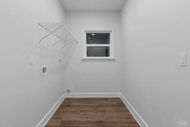 a view of a small space with wooden floor and a window