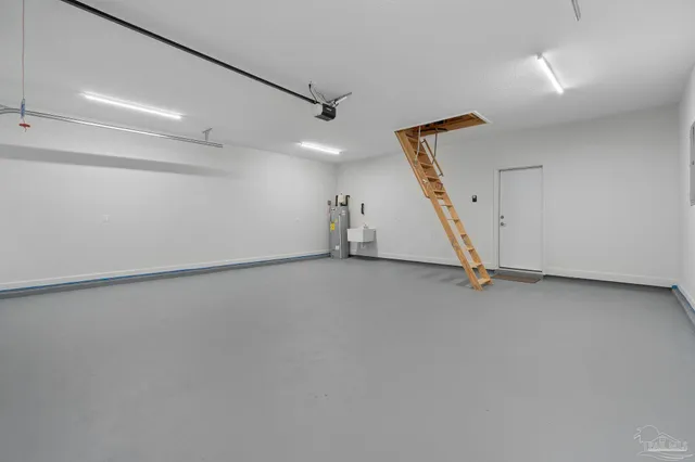 an empty room with stairs and windows