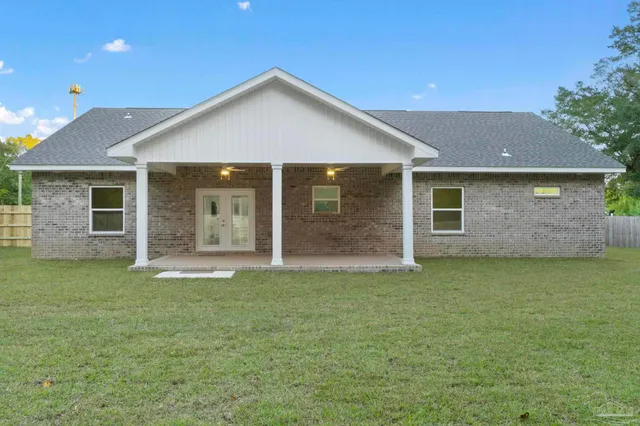 a front view of a house with a garden and yard