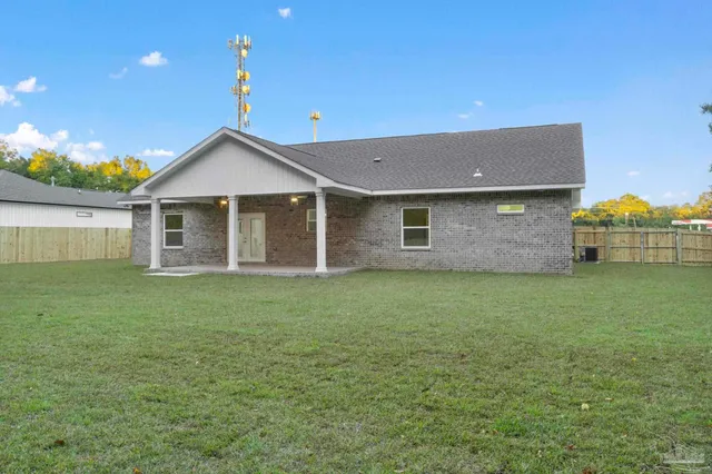 a view of a house with a backyard