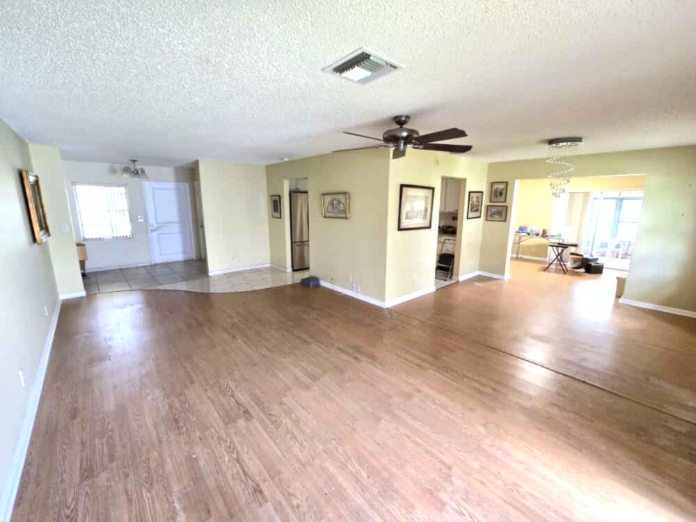 6045 Stanley Lane Delray Beach, FL 33484 - Photo 3 of 4 a view of a livingroom with furniture wooden floor and windows