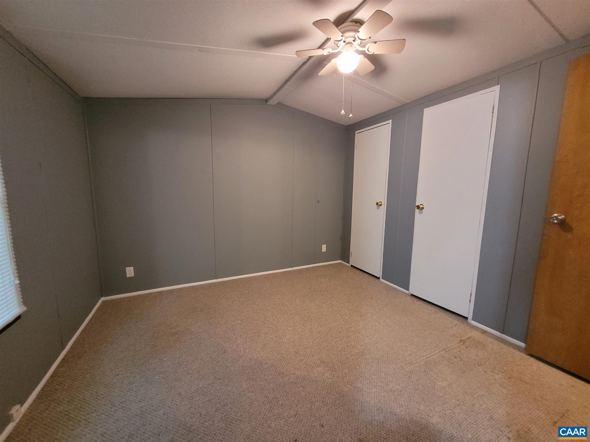 2888 Nelsons Road Esmont, VA 22937 - Photo 7 of 20 an empty room with a chandelier fan and closet area