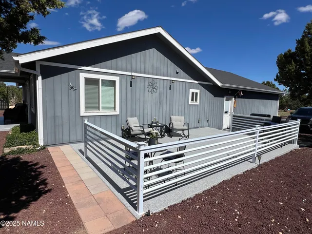 a kitchen with kitchen island granite countertop a sink cabinets and stainless steel appliances