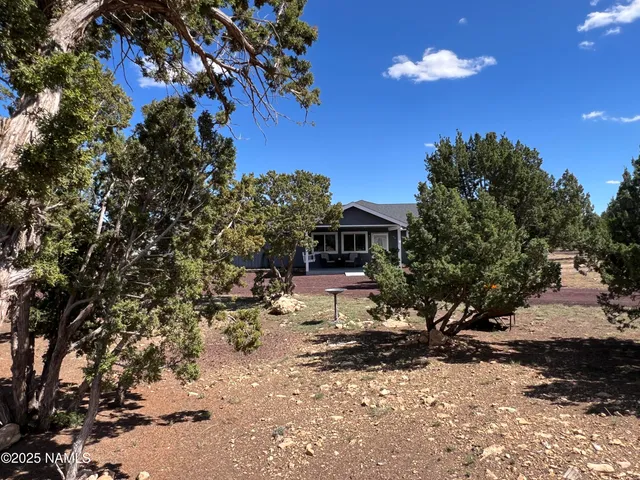 a kitchen with stainless steel appliances granite countertop a sink a stove a microwave a sink and cabinets