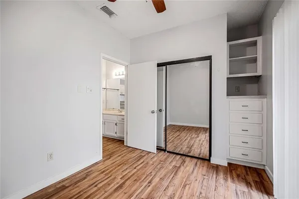 a bedroom with a bed and cabinets