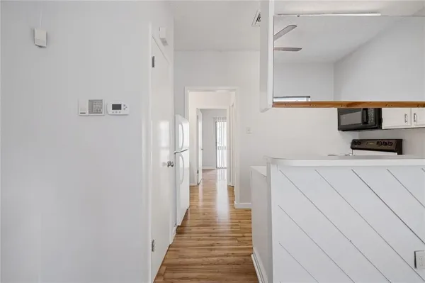 a hallway view with wooden floor