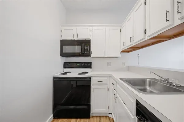 a kitchen with a sink stove and microwave