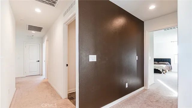 a view of hallway with wooden floor