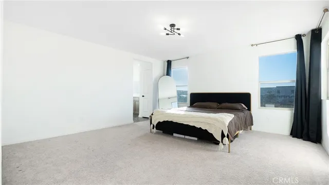 a bedroom with a bed and a lamp with window