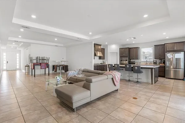 a living room with furniture a kitchen view and a kitchen view