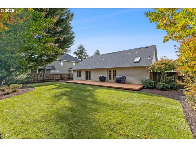 a aerial view of a house with swimming pool and a yard