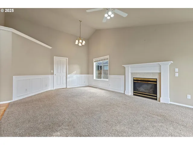 a view of empty room with a fireplace