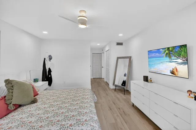 an aerial view of a house with a yard and large trees