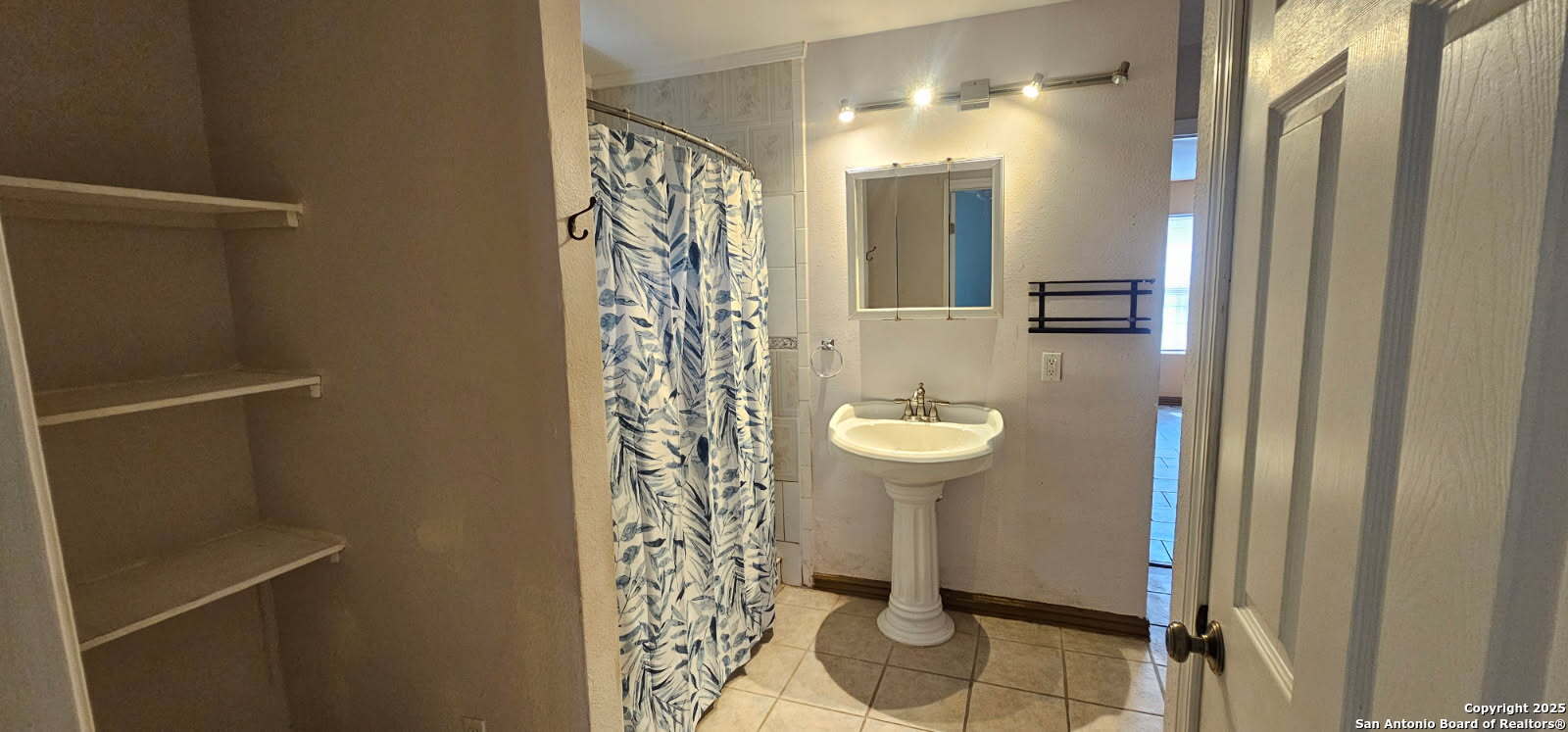 111 Rene Avenue San Antonio, TX 78233 - Photo 11 of 15 a bathroom with a sink and mirror