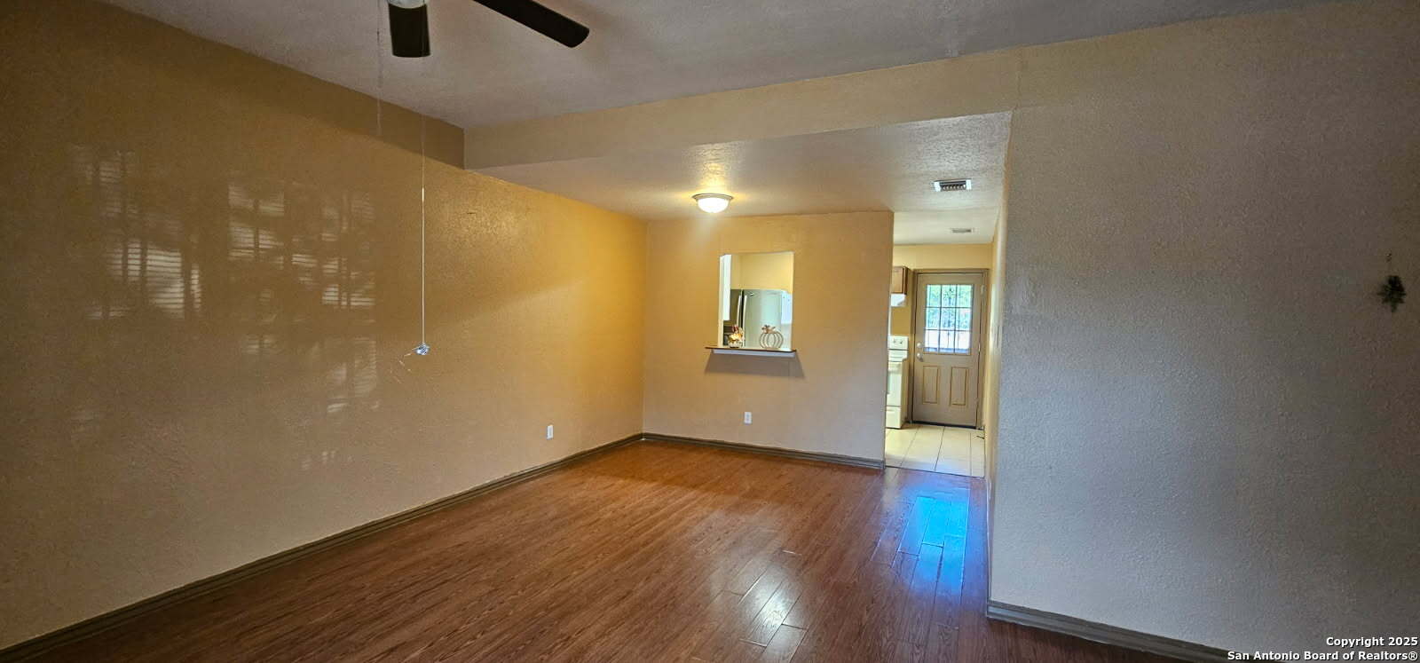 111 Rene Avenue San Antonio, TX 78233 - Photo 13 of 15 a view of an empty room with wooden floor and a window