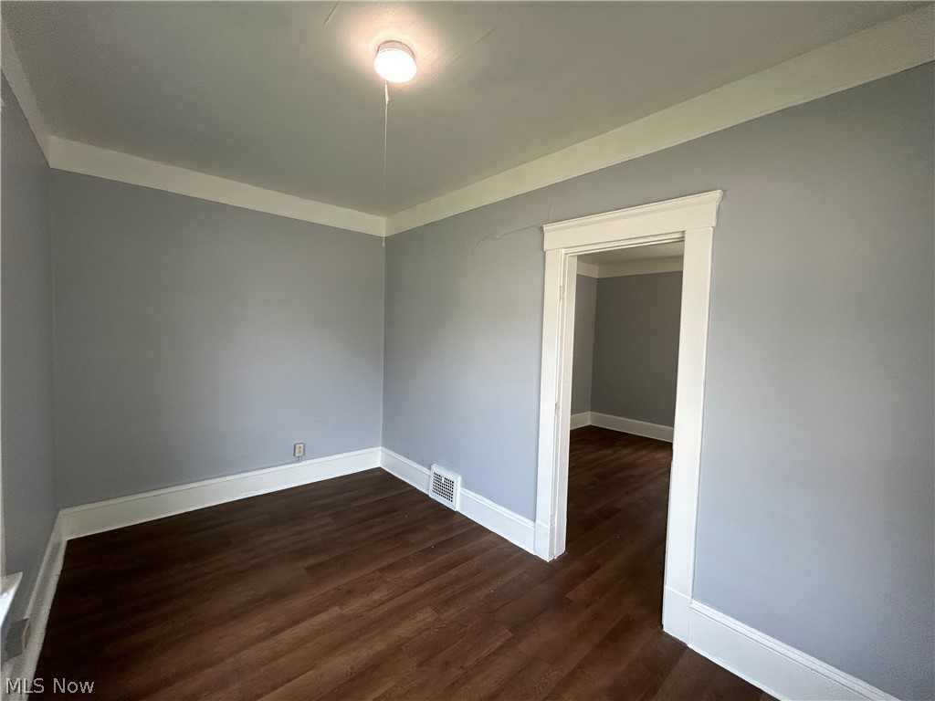 3403 Fulton Road, Unit DOWN Cleveland, OH 44109 - Photo 7 of 18 Spare room featuring dark wood-type flooring