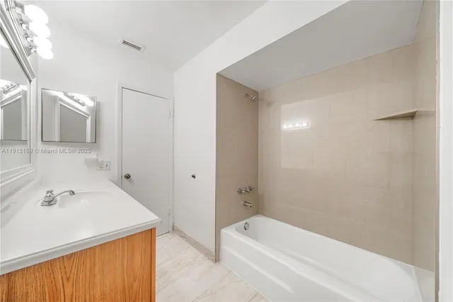 a bathroom with a granite countertop sink a toilet and a mirror