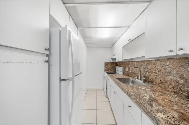 a spacious bathroom with a granite countertop shower a sink and a bathtub