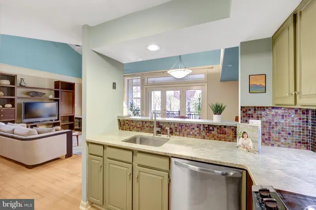 a kitchen with stainless steel appliances a sink and a stove