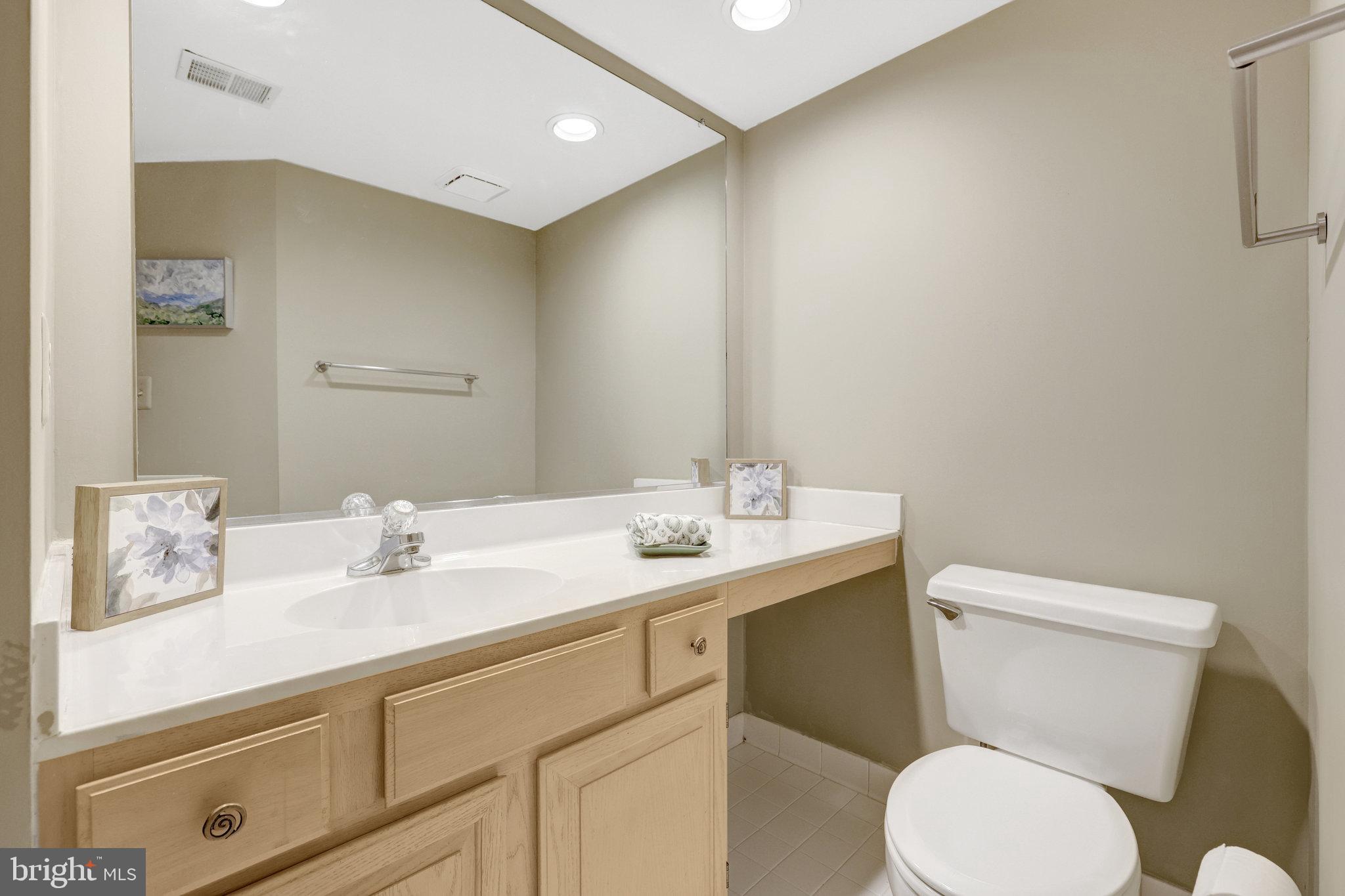 1334 Garden Wall Circle, Unit E Reston, VA 20194 - Photo 11 of 23 a bathroom with a toilet sink and mirror